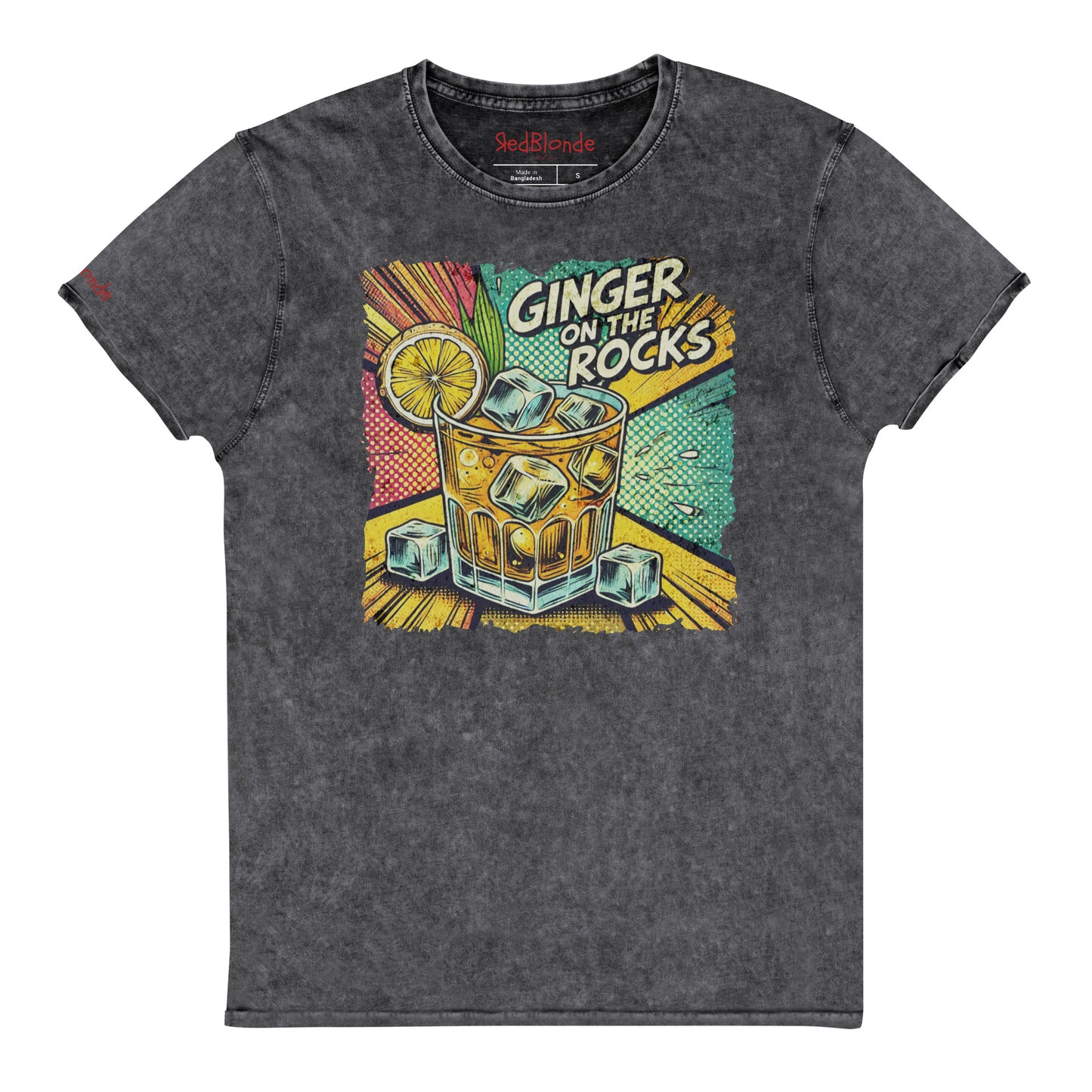 A black acid-wash unisex denim look T-shirt featuring a vibrant, retro-style graphic of a cocktail glass filled with ice cubes, a lemon slice, and the text "GINGER ON THE ROCKS" in bold comic-style lettering. The background of the graphic includes colorful pop art elements in yellow, green, and turquoise tones. Branded RedBlonde on the inside neck and right sleeve