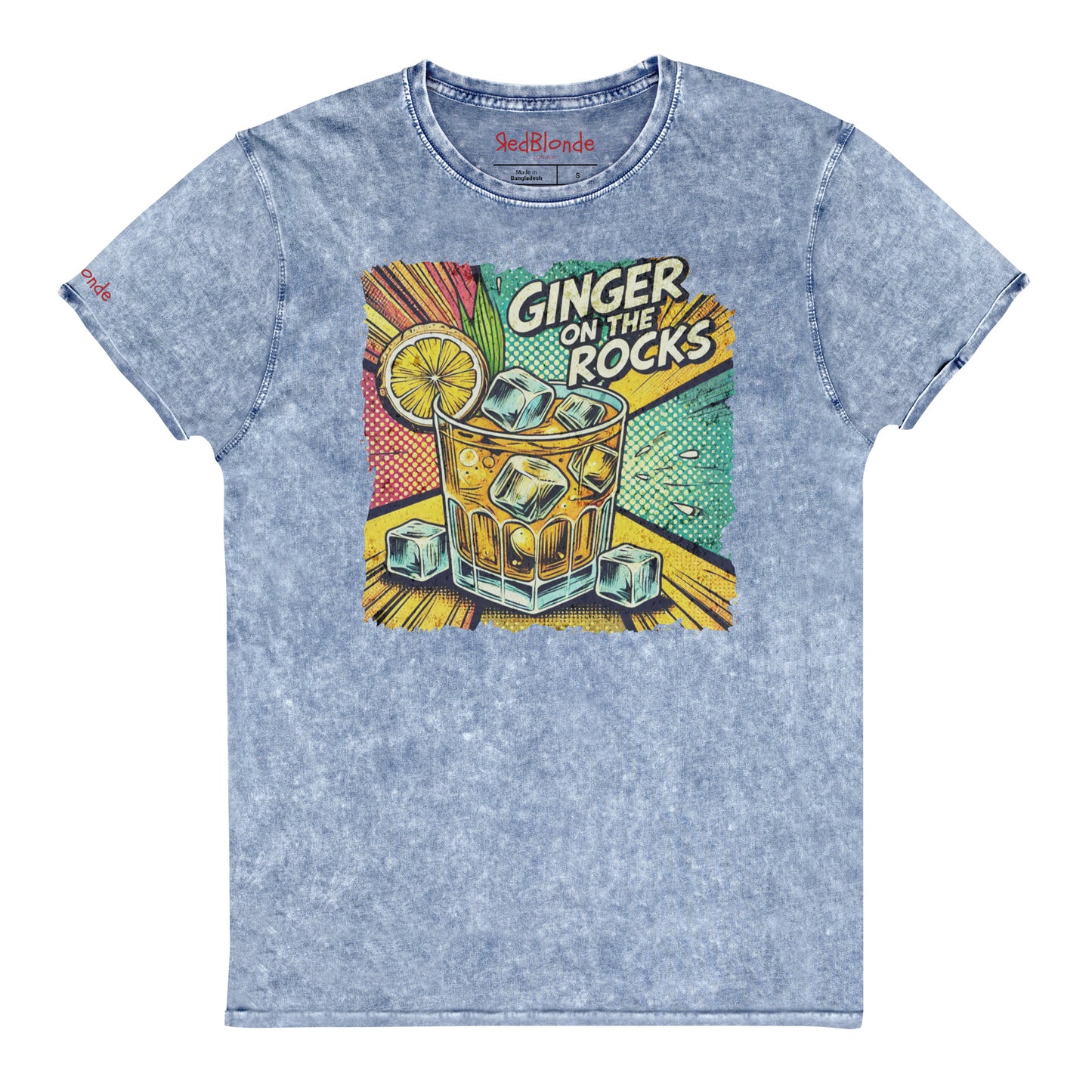 A blue acid-wash unisex denim look T-shirt featuring a vibrant, retro-style graphic of a cocktail glass filled with ice cubes, a lemon slice, and the text "GINGER ON THE ROCKS" in bold comic-style lettering. The background of the graphic includes colorful pop art elements in yellow, green, and turquoise tones. Branded RedBlonde on the inside neck and right sleeve