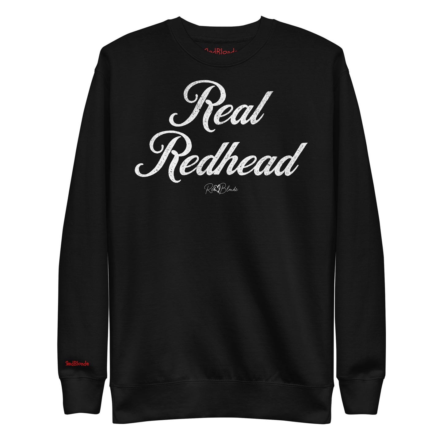A classic black relaxed fit unisex sweatshirt with the words 'Real Redhead' written in red vintage milkstore font, like coco cola script. Branded RedBlonde London in red on inside neck and right sleeve