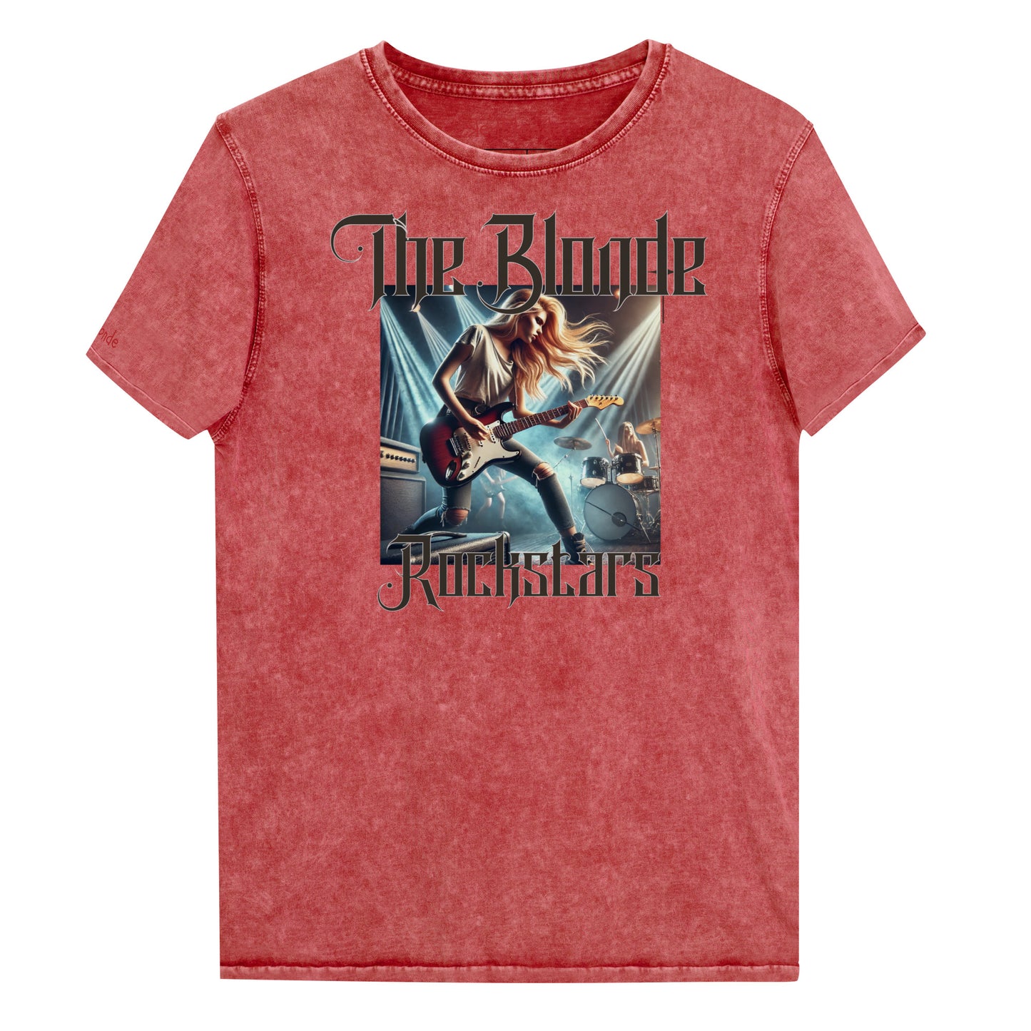 A garnet red denim wash unisex t-shirt with a graphic of a blonde female rock guitarist on stage with a drummer in the background, illuminated by stage lights. The text ‘The Blonde Rockstars’ is in bold, metallic avalen rekas font above and below the image. Branded RedBlonde London in red on the inside neck and right sleeve.