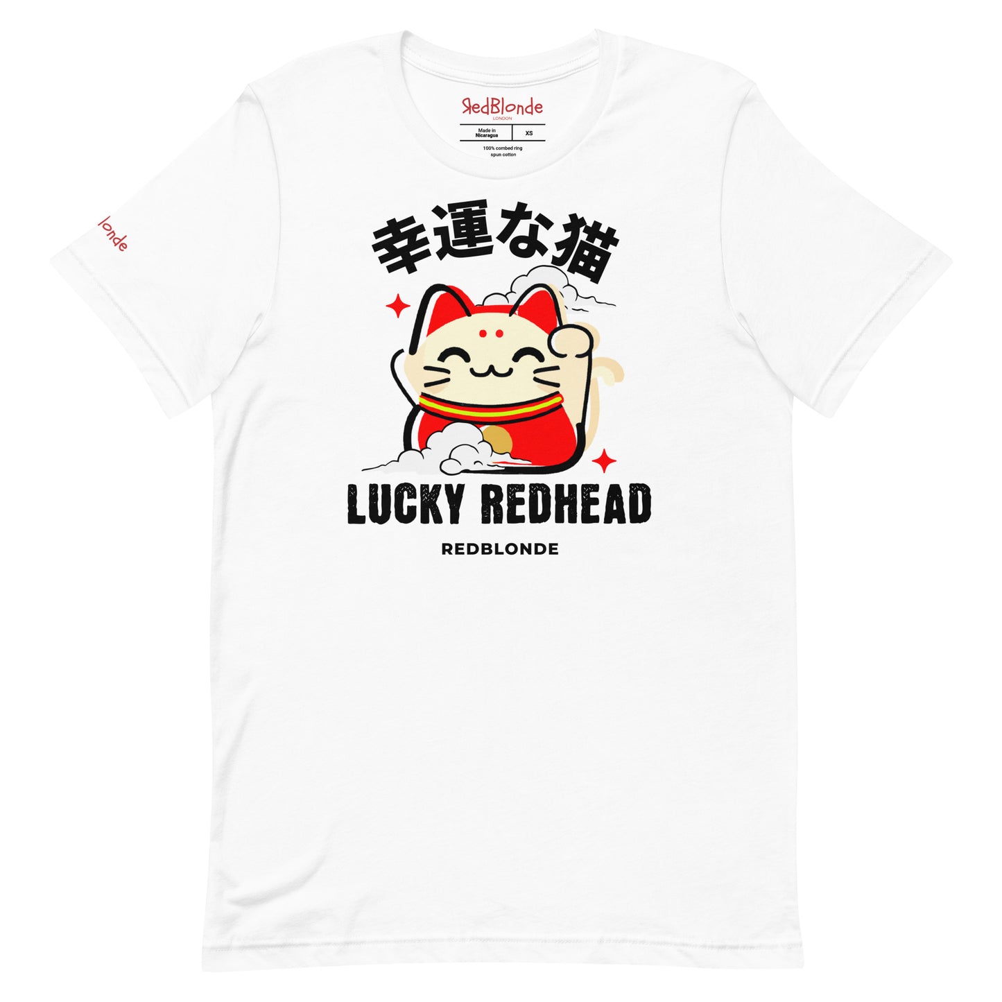 A white unisex T-shirt featuring a colorful maneki-neko (lucky cat) graphic wearing a red outfit with gold accents. Above the cat, Japanese kanji characters are printed in bold white. Below the illustration, the text reads “LUCKY REDHEAD” in distressed white font, with “REDBLONDE” in smaller uppercase letters underneath. The shirt has short sleeves, a classic crew neckline, and a casual, modern fit.
