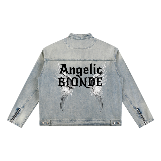 A light-wash denim jacket shown from the back on a white background. The sleeves have zippered cuffs, and the back features a large graphic with white angel wings and black gothic New Rocker style text reading “Angelic BLONDE.”