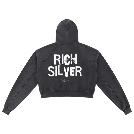 Back view of a cropped snow-wash black hoodie with bold black “RICH SILVER” Ed Gein font and the RedBlonde signature logo printed below.