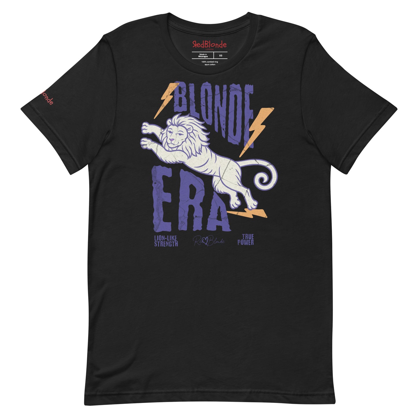 Black unisex short-sleeve t-shirt featuring a bold graphic of a leaping lion outlined in purple, surrounded by orange lightning bolts. The text “BLONDE ERA” appears in large distressed purple letters, with smaller text reading “LION-LIKE STRENGTH” and “TRUE POWER” underneath. Signed RedBlonde. The brand name “RedBlonde” is printed in red on the inside collar label and on the right sleeve near the cuff.