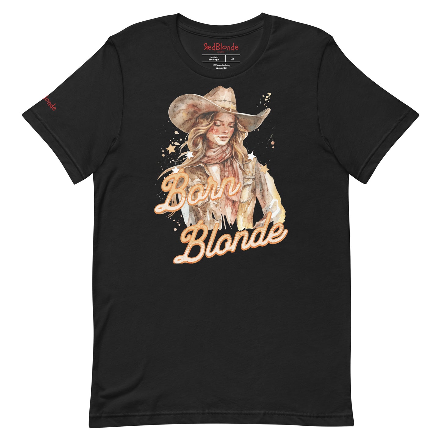 Black unisex t-shirt featuring a watercolor-style illustration of a blonde cowgirl wearing a wide-brimmed hat and scarf. The graphic includes the slogan “Born Blonde” in a bold, vintage-style adventurer font. RedBlonde branding appears on the inner neck label and right sleeve.