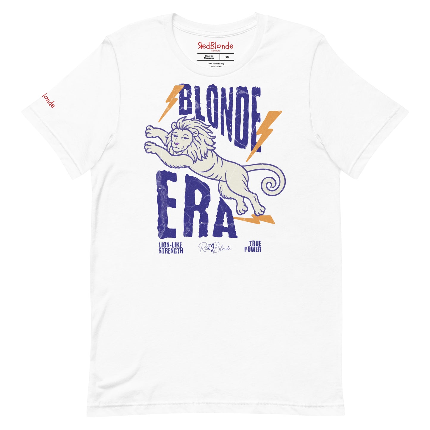 White unisex short-sleeve t-shirt featuring a bold graphic of a leaping lion outlined in purple, surrounded by orange lightning bolts. The text “BLONDE ERA” appears in large distressed purple letters, with smaller text reading “LION-LIKE STRENGTH” and “TRUE POWER” underneath. Signed RedBlonde. The brand name “RedBlonde” is printed in red on the inside collar label and on the right sleeve near the cuff.