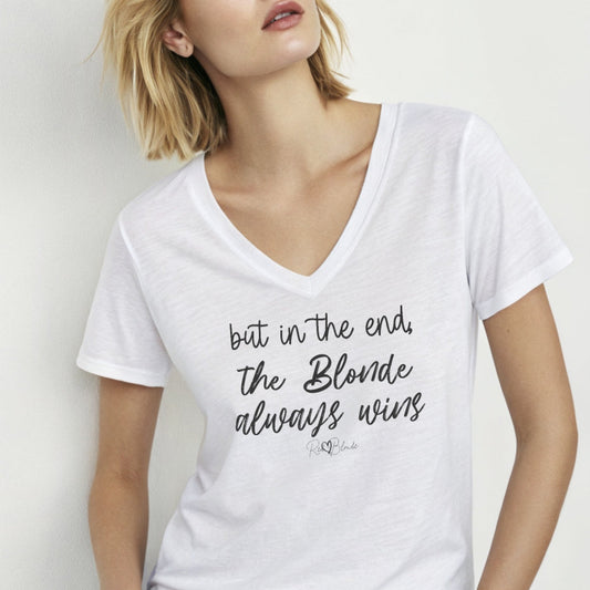 Blonde woman wears white women's v-neck relaxed fit t-shirt featuring the handwritten-style slogan “but in the end, the Blonde always wins” in Hillbear font in black text across the chest, signed off RedBlonde. Branded “RedBlonde London on inside the collar and on the right sleeve