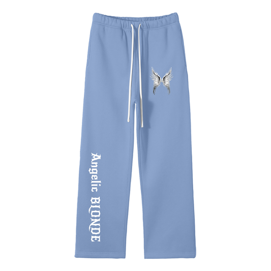 Blue wide-leg joggers with white drawstrings, featuring a small white angel-wing graphic on the upper left thigh and ‘Angelic Blonde’ printed vertically down the right leg in New Rocker gothic style lettering, shown flat against a white background.