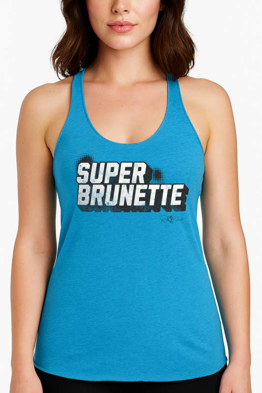 Brunette wears a Women’s vintage turquoise racerback tank top with bold black “SUPER BRUNETTE” in Univercity font block comic-style font with halftone detail, featuring the RedBlonde logo signature beneath the design.
