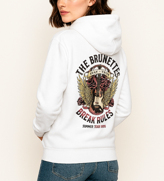 Brunette wears a reverse side of a white 3 panel unisex classic hoodie with a burnt pink & beige graphic of a guitar with bird wings emerging from the side. The graphic features ‘THE BRUNETTES’ in Brookfield font above the guitar, ‘STAY TRUE’ across the top, and ‘BREAK RULES - Summer Tour 1995’ underneath. Branded RedBlonde London in inside neck and embroidered RedBlonde on front top right breast area.