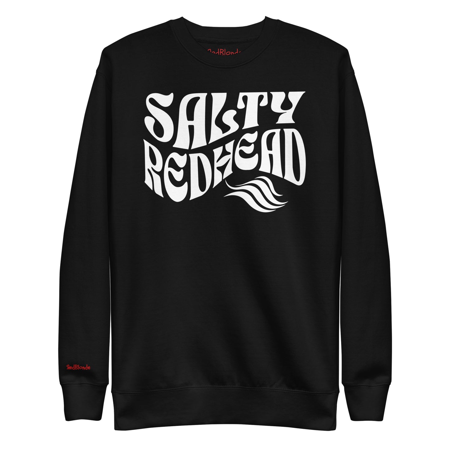 flatlay of Classic relaxed fit unisex sweatshirt in black with 'Salty Redhead' play on words slogan in white retro wavy 70s text. Branded RedBlonde on inside neck and right cuff in red