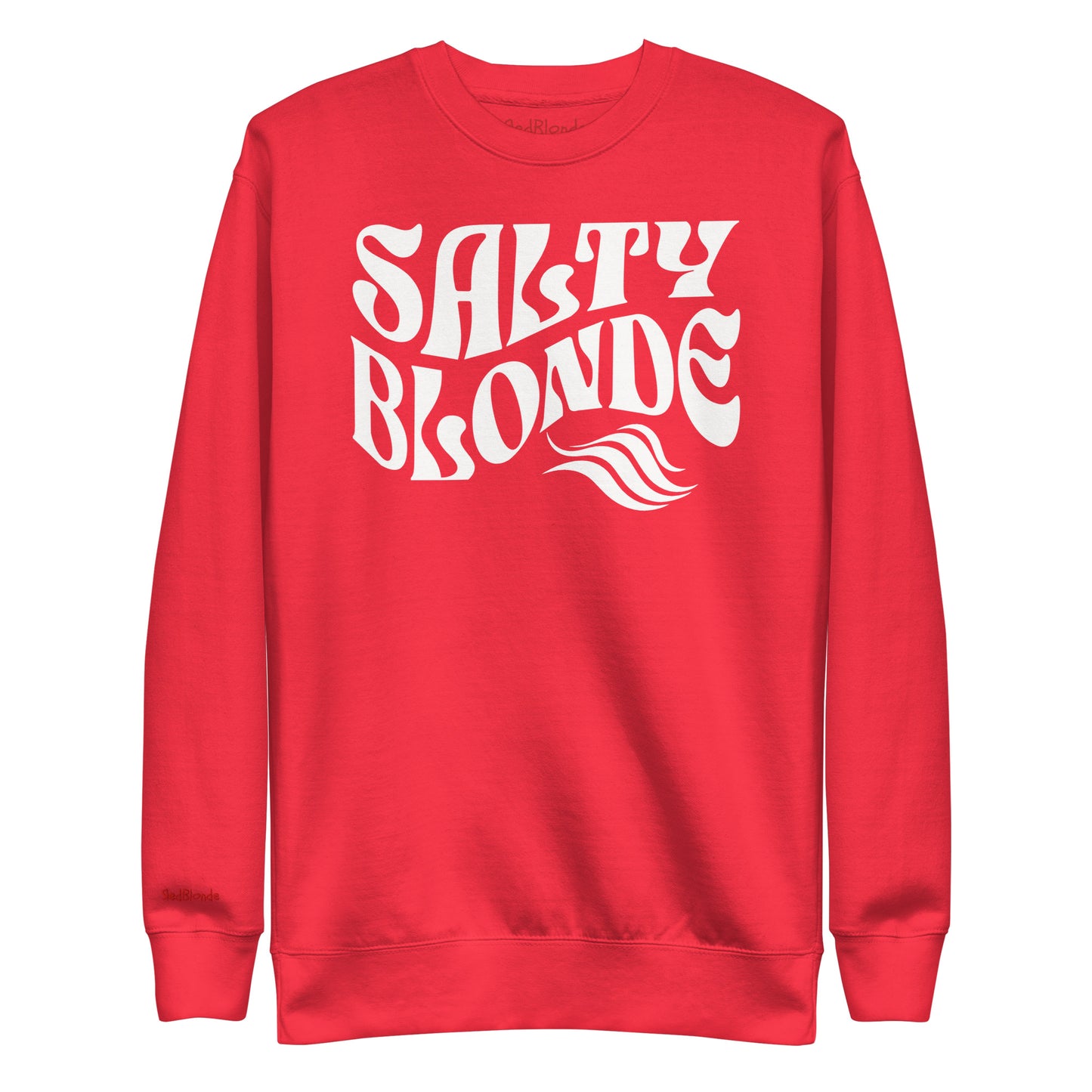 flatlay of Classic relaxed fit unisex sweatshirt in red with 'Salty Blonde' play on words slogan in white retro 70s wavy text. Branded RedBlonde on inside neck and right cuff in red