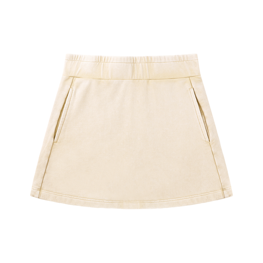 Front view of a cream mineral-wash mini skirt with a mid-rise elastic waistband, subtle A-line/H-line shape, and side slash pockets.