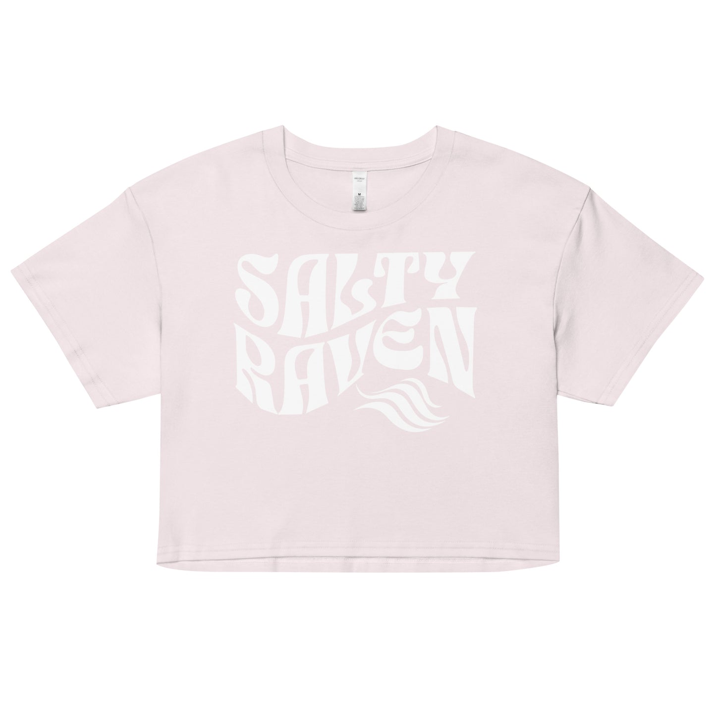 Flatlay of a orchid pale pink loose crop top t-shirt with the words ‘Salty Raven’ in white retro 70s wavy font