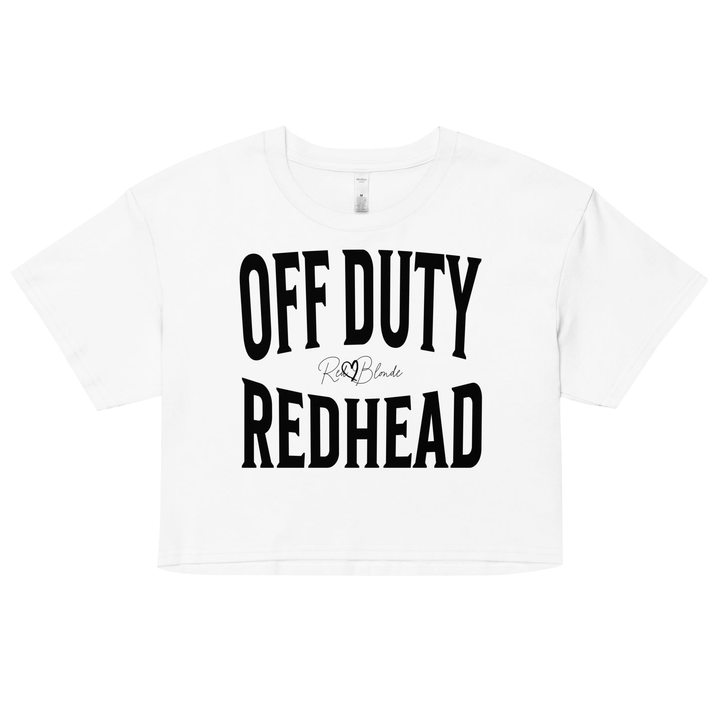 Flatlay of a white women's crop top graphic t-shirt with “OFF DUTY REDHEAD” in black Helvetica Now font emblazoned on the front, signed off RedBlonde