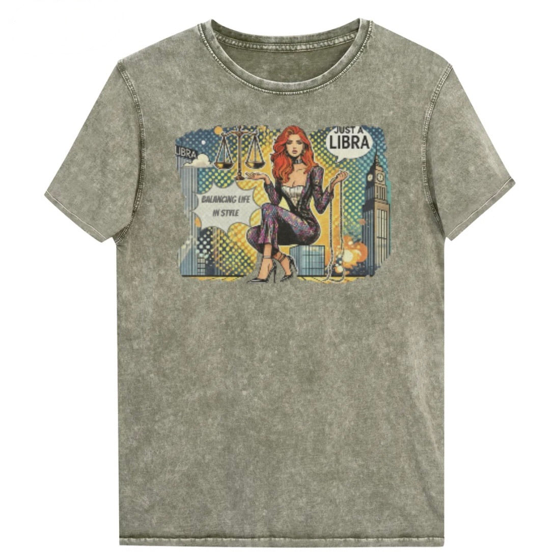 Flatlay of a unisex army green denim wash vintage t-shirt with a retro pop-art redhead Libra graphic featuring a redhead woman, scales, and a city backdrop, captioned ‘Just a Libra, Balancing Life in Style’. Branded RedBlonde on inside neck and right sleeve
