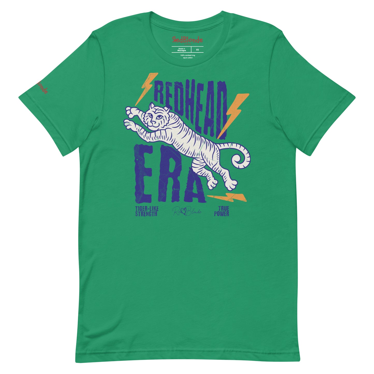 Kelly green unisex short-sleeve t-shirt featuring a bold graphic of a leaping tiger outlined in purple, surrounded by orange lightning bolts. The text “REDHEAD ERA” appears in large distressed purple letters, with smaller text reading “TIGER-LIKE STRENGTH” and “TRUE POWER” underneath. Signed RedBlonde. The brand name “RedBlonde” is printed in red on the inside collar label and on the right sleeve near the cuff.