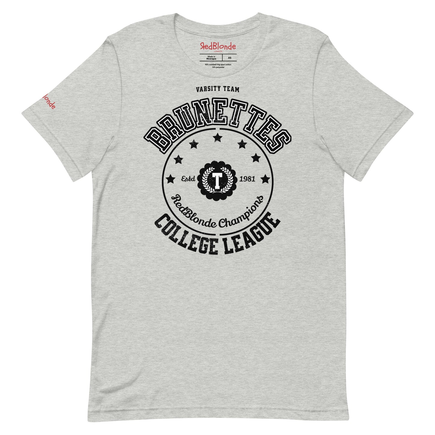 Light grey unisex t-shirt featuring a bold black collegiate-style graphic that reads "BRUNETTES COLLEGE LEAGUE" with stars and a central crest emblem. The design includes "Varsity Team," "RedBlonde Champions," and "Estd 1981" details. RedBlonde branding appears on the inner neck label and left sleeve in red text.