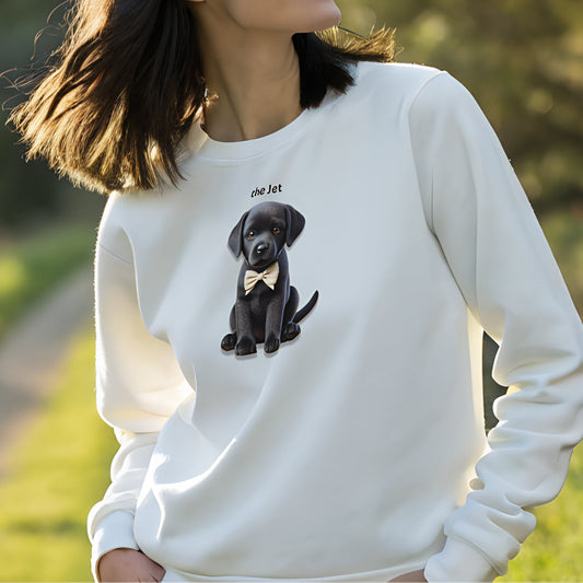 Model with black hair wearing white relaxed fit unisex sweatshirt with a cute graphic of a jet black puppy wearing a bow-tie and the words 'the Jet' linking to Black hair. Branded RedBlonde in red on inside neck and right cuff