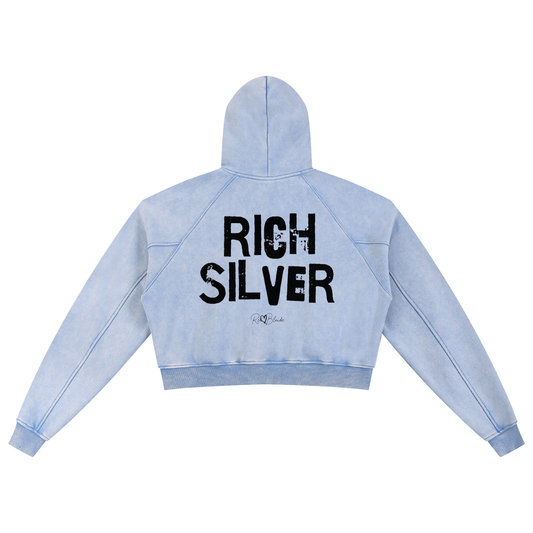 Back view of a cropped snow-wash pale blue hoodie with bold black “RICH SILVER” Ed Gein font and the RedBlonde signature logo printed below.