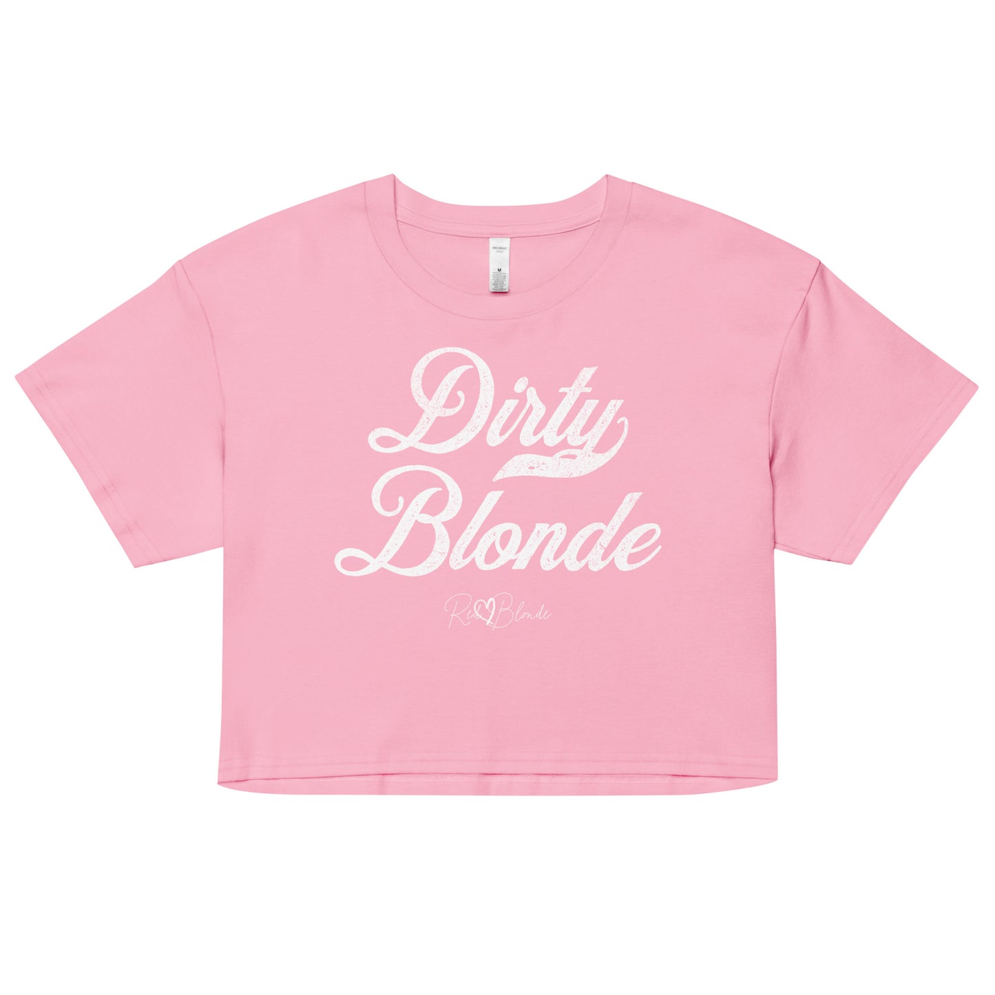 Pink women’s crop top featuring the phrase “Dirty Blonde” in bold, white milkstore vintage-style script across the chest. Below the phrase, the brand name “RedBlonde” is printed in a smaller, elegant handwritten font.