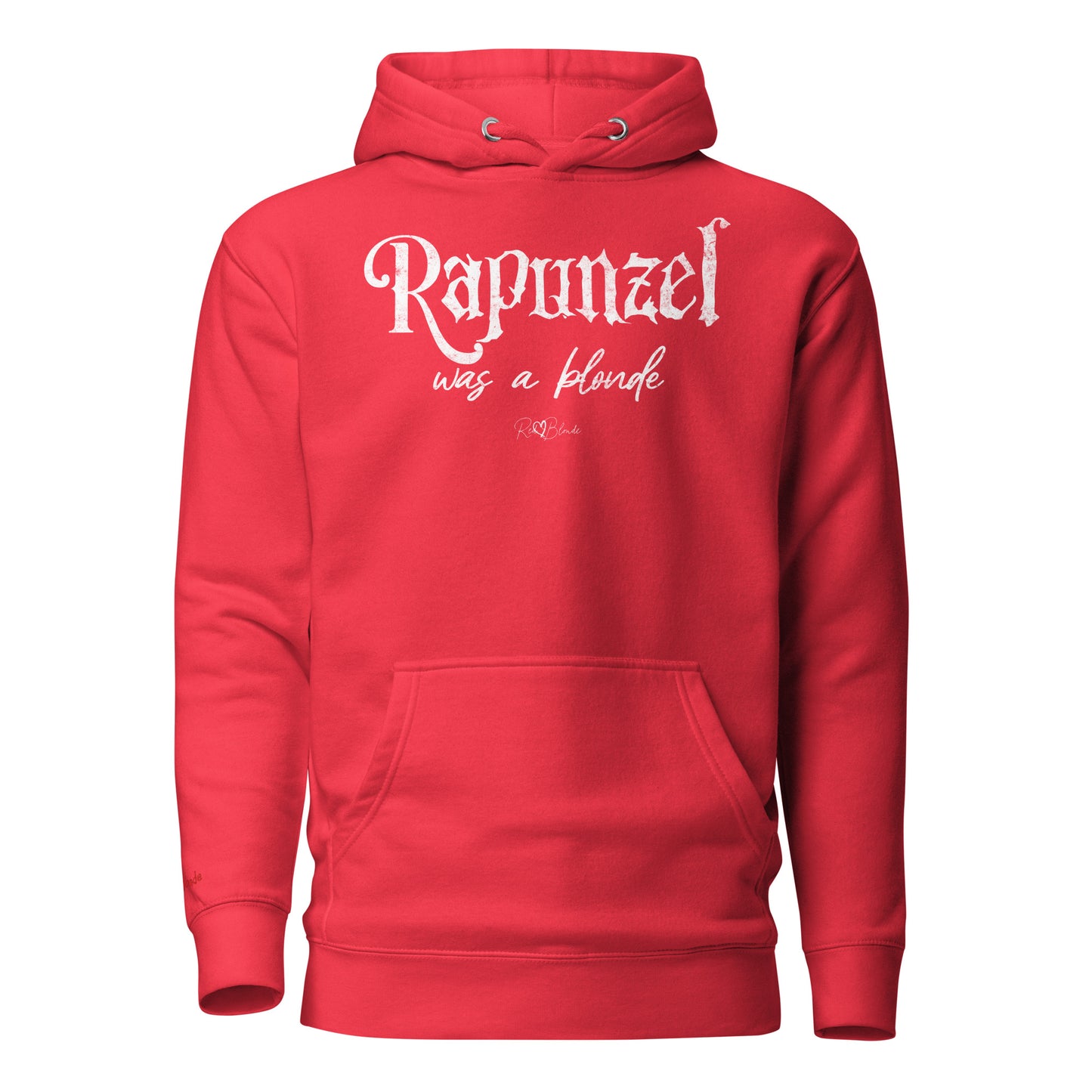 Bold red unisex pullover hoodie with kangaroo pocket and adjustable drawstrings. The front features distressed white lettering that reads “Rapunzel was a blonde” in a mix of gothic and script fonts, with the RedBlonde signature logo beneath. Branded RedBlonde on inside neck and right sleeve