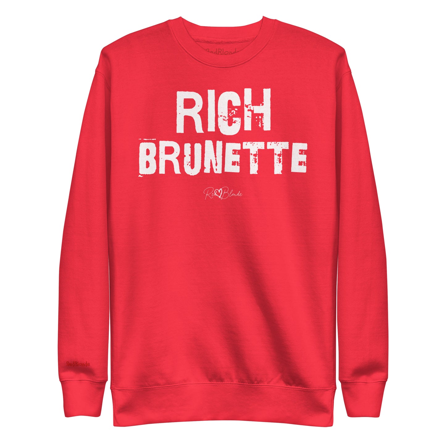 Red unisex premium sweatshirt with bold distressed white Ed Geinitext “RICH BRUNETTE” on the front, featuring a subtle RedBlonde logo beneath the lettering and on the sleeve cuff and inside neck