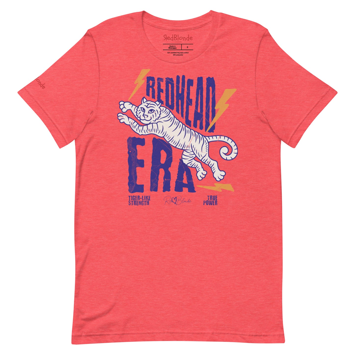 Red unisex short-sleeve t-shirt featuring a bold graphic of a leaping tiger outlined in purple, surrounded by orange lightning bolts. The text “REDHEAD ERA” appears in large distressed purple letters, with smaller text reading “TIGER-LIKE STRENGTH” and “TRUE POWER” underneath. Signed RedBlonde. The brand name “RedBlonde” is printed in red on the inside collar label and on the right sleeve near the cuff.