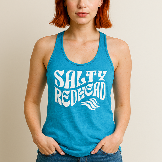 Redhead wears a blue turquoise soft racerback tank t-shirt with 'Salty Redhead' play on words slogan in white retro wavy 70s font. Branded RedBlonde London on reverse