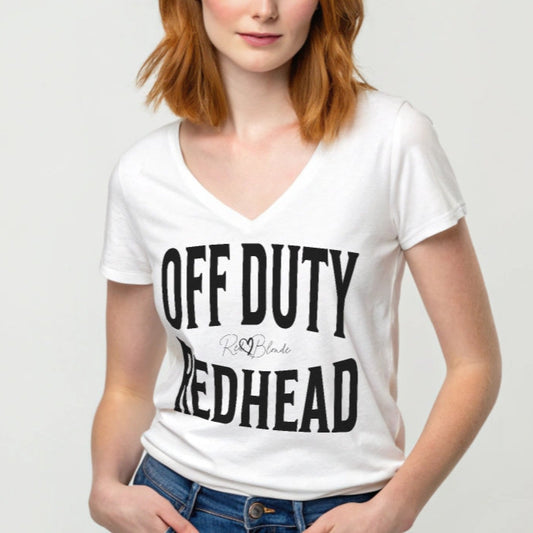 Redhead wears a white relaxed fit unisex v-neck t-shirt with the words 'OFF DUTY REDHEAD' written in large Brookfield black font, across the front. Branded RedBlonde London in red on inside neck and right sleeve