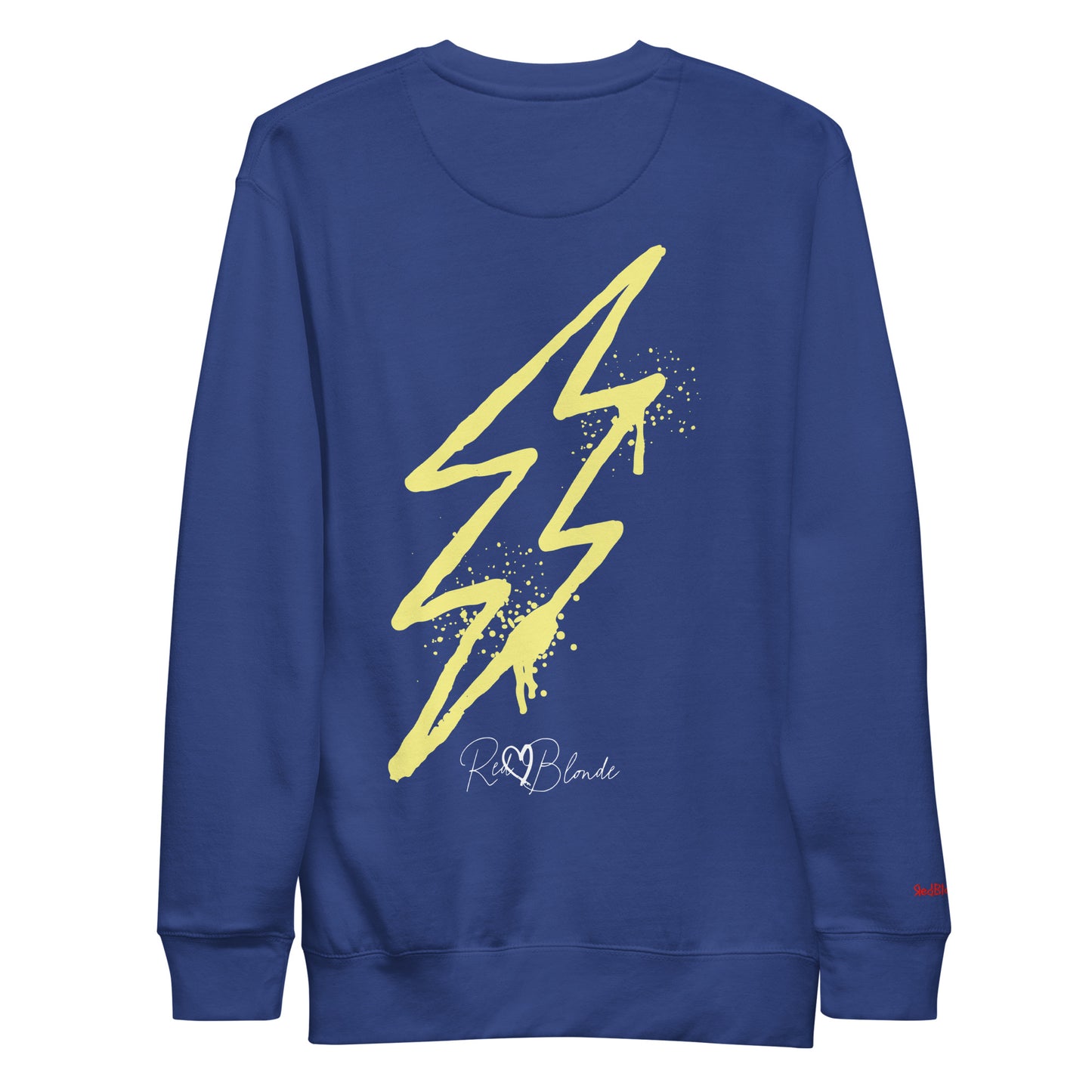 Back view of a Royal Blue unisex sweatshirt featuring a bold yellow lightning bolt graphic with paint-splatter detail and the RedBlonde logo printed below. The design has an edgy, electric streetwear vibe. Branded RedBlonde in red on right sleeve