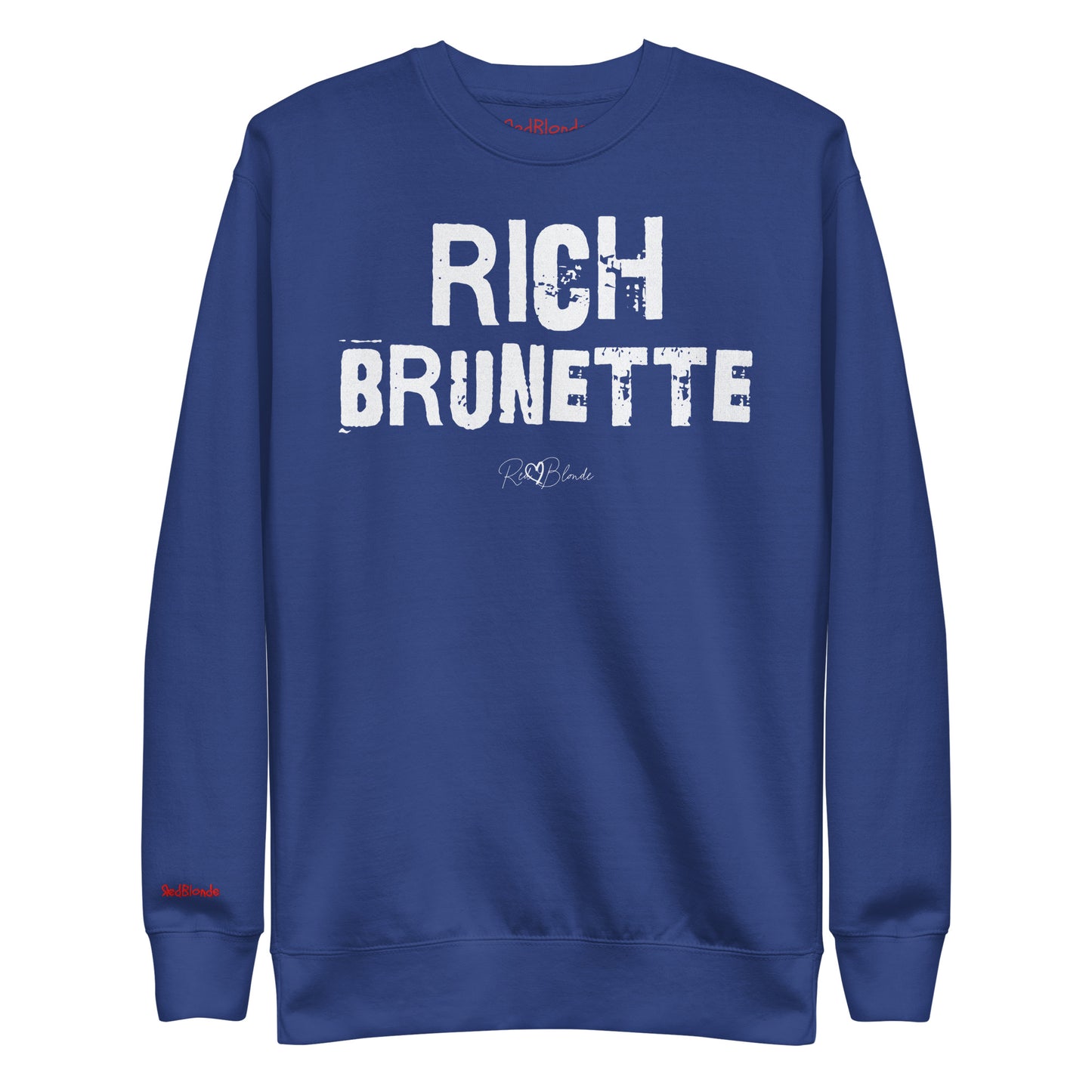 Royal Blue unisex premium sweatshirt with bold distressed white Ed Geinitext “RICH BRUNETTE” on the front, featuring a subtle RedBlonde logo beneath the lettering and on the sleeve cuff and inside neck