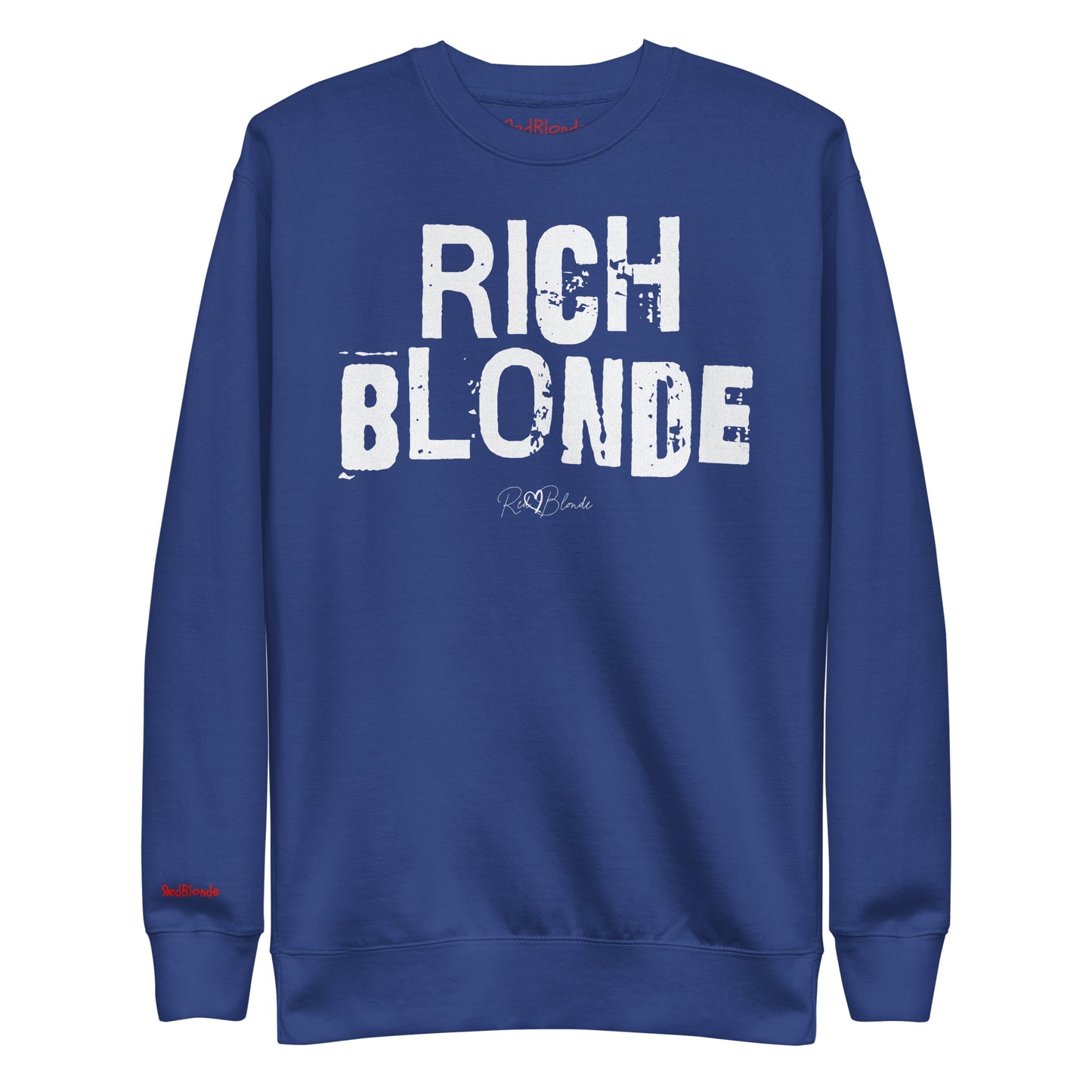 Royal Blue unisex premium sweatshirt with bold distressed white Ed Geinitext “RICH BLONDE” on the front, featuring a subtle RedBlonde logo beneath the lettering and on the sleeve cuff and inside neck
