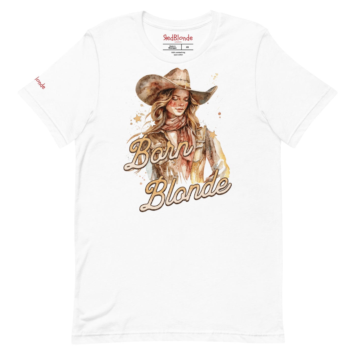 White unisex t-shirt featuring a watercolor-style illustration of a blonde cowgirl wearing a wide-brimmed hat and scarf. The graphic includes the slogan “Born Blonde” in a bold, vintage-style adventurer font. RedBlonde branding appears on the inner neck label and right sleeve.