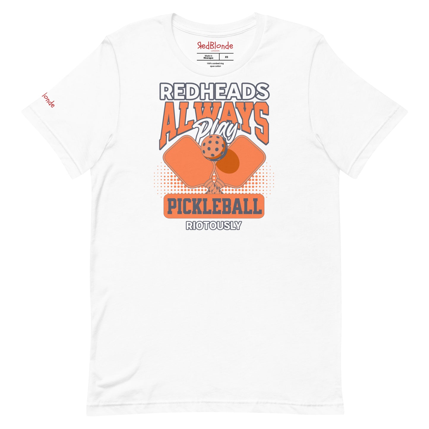 White unisex t-shirt with orange graphic that reads "Redheads Always Play Pickleball Riotously," featuring pickleball paddles and ball. Branded RedBlonde on inside neck and right sleeve