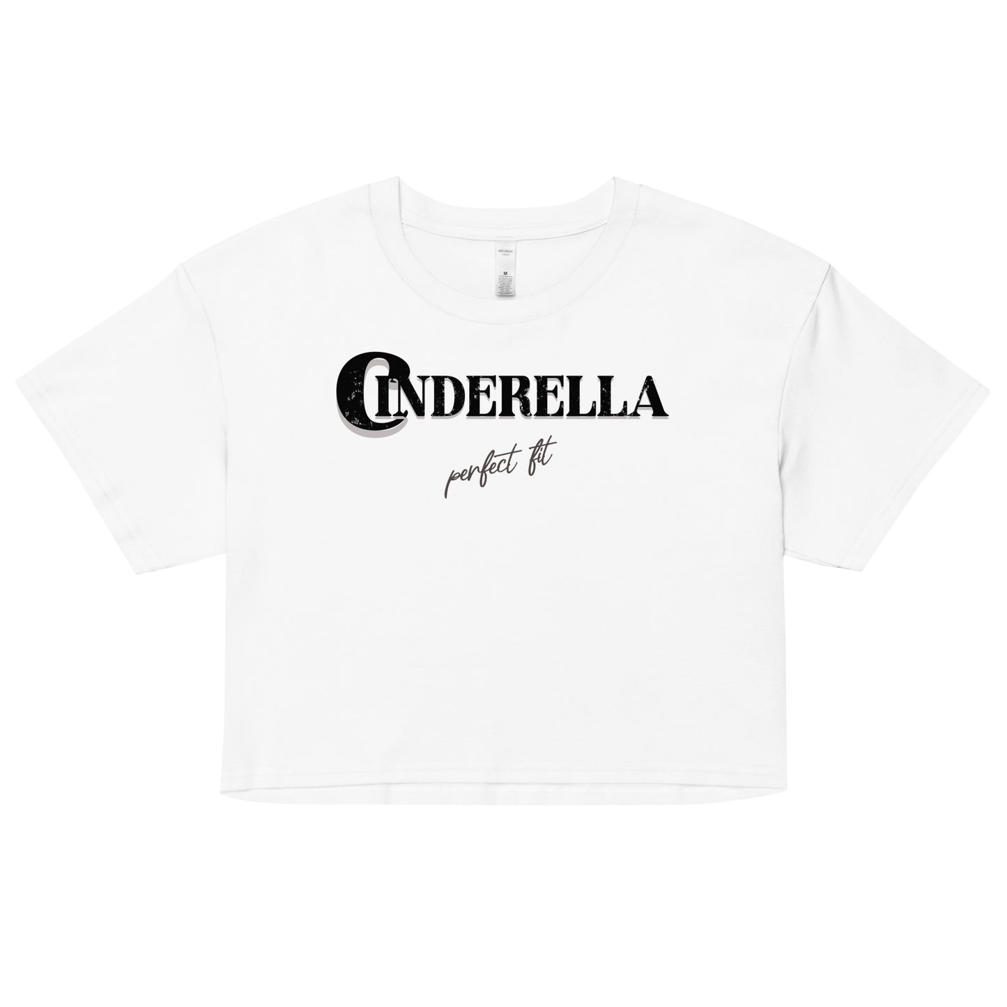 White women’s crop top featuring black merger text that reads “Cinderella” with a decorative crescent moon incorporated into the letter C, and the phrase “perfect fit” written underneath in an elegant cursive script.