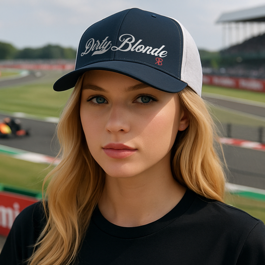 Woman wearing a black & white trucker cap with 'Dirty Blonde' in Milkstore font in white on a race track background. branded RedBlonde