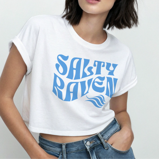 Woman wearing a white crop t-shirt with 'Salty Raven' printed in blue Solino display font