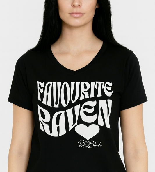 Woman with jet black hair wears Black women's loose fit v-neck graphic t-shirt with the slogan 'Favourite Raven' in Solino Display white retro 70s wavy font. Signed with a heart and RedBlonde. Branded RedBlonde in red on inside neck and right sleeve