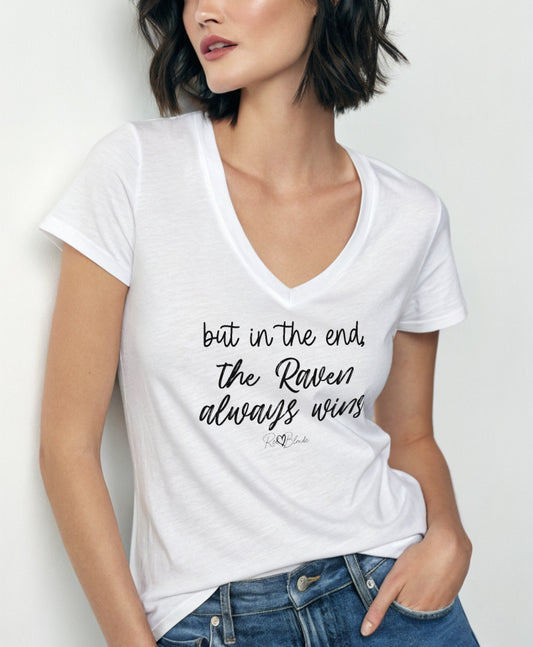 Women with jet black hair wears a white women's v-neck relaxed fit t-shirt featuring the handwritten-style slogan “but in the end, the Raven always wins” in Hillbear font in black text across the chest, signed off RedBlonde. Branded “RedBlonde London on inside the collar and on the right sleeve