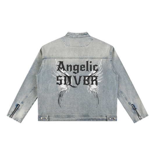 A light-wash denim jacket shown from the back on a white background. The sleeves have zippered cuffs, and the back features a large graphic with white angel wings and black gothic New Rocker style text reading “Angelic SILVER”
