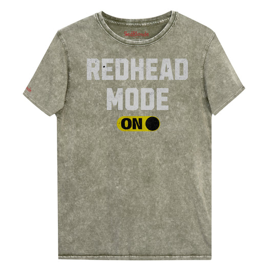 army green denim-style unisex t-shirt with bold distressed white Univercity font reading “Redhead Mode” and a yellow on/off switch graphic in the “On” position beneath. The design includes subtle worn texture for a vintage look. Branded RedBlonde London in red on inside neck and right sleeve