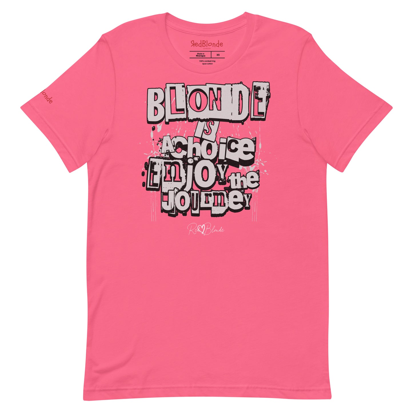 A berry pink unisex T-shirt with a classic crew neckline and short sleeves. The front displays a bold, graffiti-style text design in black, white, and gray. The words read: “BLONDE is a choice, ENJOY the JOURNEY” with varied fonts and a layered street-art effect. The RedBlonde brand name is subtly printed below in a handwritten script. Branded RedBlonde london in red on inside neck and right sleeve