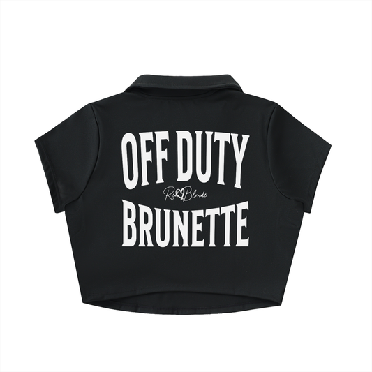 Black cropped polo shirt with large white “OFF DUTY BRUNETTE” Brookfield text on the back and a small RedBlonde script logo beneath.