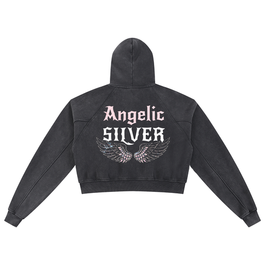 Back view of a black cropped hoodie with hood up, featuring “Angelic Silver” New Rocker font text and iridescent angel wings graphic printed across the back on a white background.