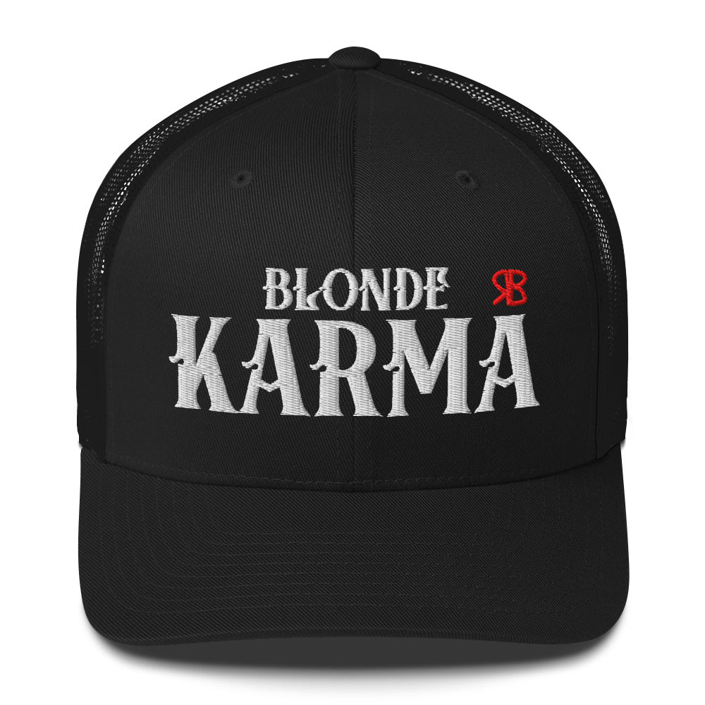 black retro trucker cap with mesh back. The front features bold white embroidered text reading "BLONDE KARMA" with a small red RB logo to the right.
