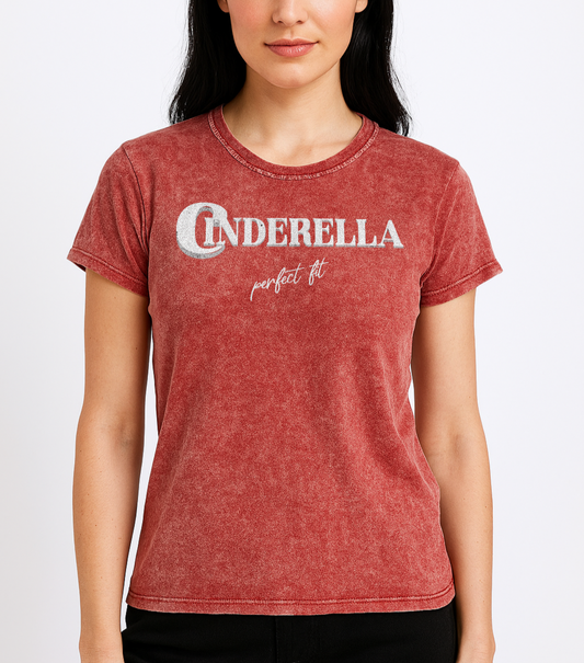 black haired woman wears Red acid wash vintage look unisex t-shirt featuring white merger text that reads “Cinderella” with a decorative crescent moon incorporated into the letter C, and the phrase “perfect fit” written underneath in an elegant cursive script.