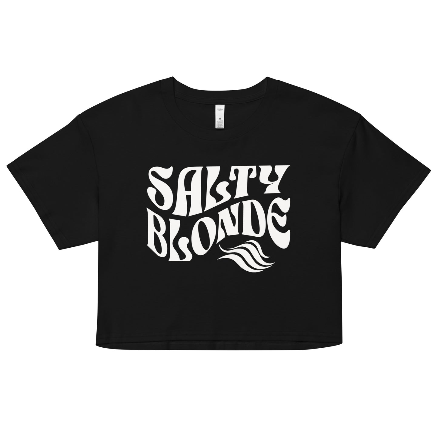 Flatlay of a black loose crop top t-shirt with the words ‘Salty Blonde’ in white retro 70s wavy font