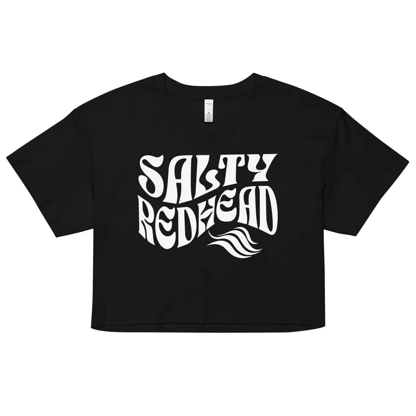 Flatlay of a black loose women's crop top t-shirt with the words ‘Salty Redhead’ in retro 70s wavy text in white.