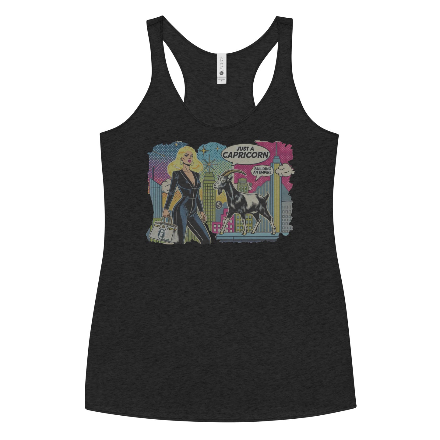 Flatlay of a heather black soft racerback tank t-shirt with a retro pop-art Blonde Capricorn graphic featuring a blonde woman in a black catsuit, carrying a bag, with a goat and a city skyscraper backdrop, captioned ‘Just a Capricorn, Building an empire'